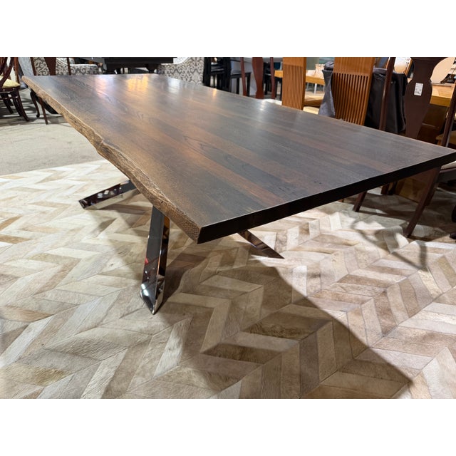 Bring together organic warmth and modern industrial sophistication with this striking live edge dining table, a bold...