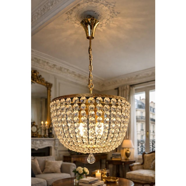 A stunning crystal chandelier dating from the 1950s, offering a refined and luminous presence, ideal for enhancing an...