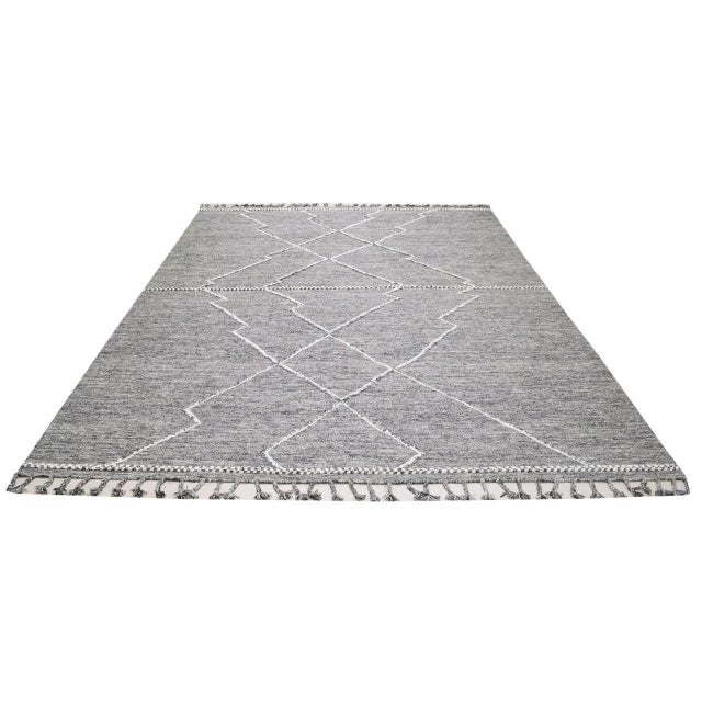 Moroccan Beni Ourain hand knotted wool rug with diamond pattern.