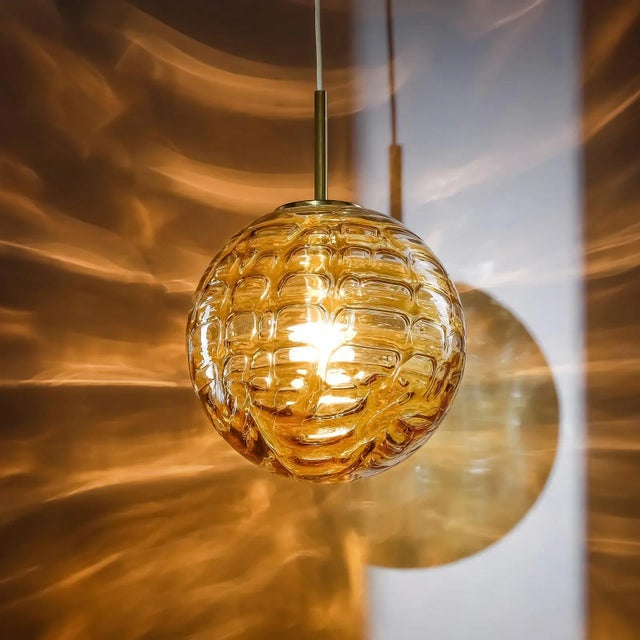 The decorative murano glass pendant lamp from the 1970s was made by the renowned german lighting company doria. It is made...