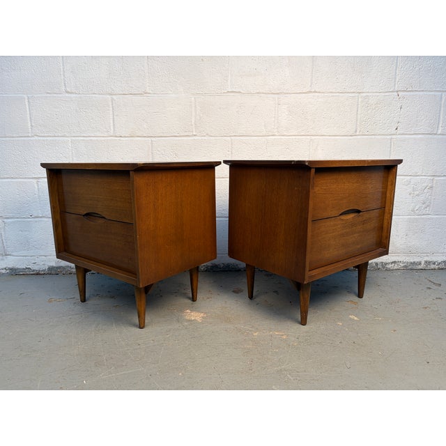 A handsome pair of mid-century modern walnut nightstands featuring beautifully crafted dovetail drawers. Showcasing clean...