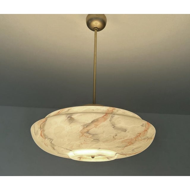 Art Deco pendant lamp with a light sage green marble Uranium glass shade with orange charcoal veins, brass glass cover,...