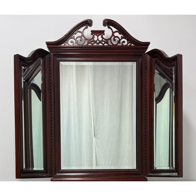 A Chippendale style tri-fold dresser mirror by Thomasville, from their The Mahogany Collection. Mahogany with a fretwork...