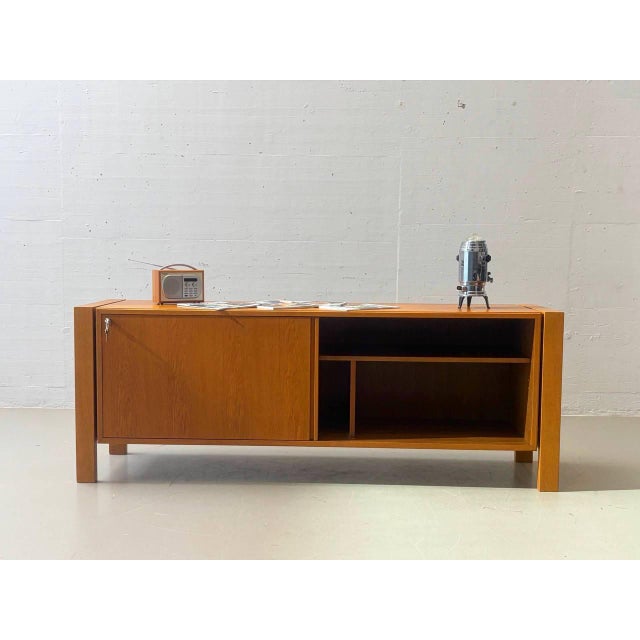 A generously sized mid-century sideboard from the 1960s with a particularly clean and architectural design. The wide, low...