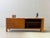 A generously sized mid-century sideboard from the 1960s with a particularly clean and architectural design. The wide, low...