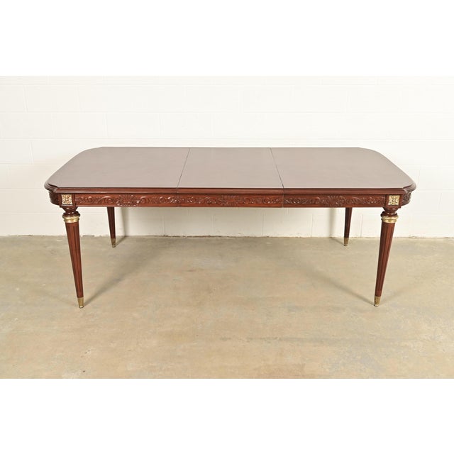 An exceptional French Regency Louis XVI style extension dining table In the manner of Maison Jansen France, Circa Mid-20th...