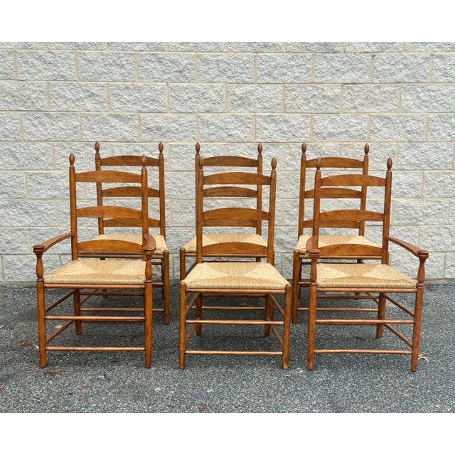 A set of 6 charming dining chairs with rush seats. 2 captain chairs, 4 side chairs Dimensions: captain chairs: 25" w 18" d...