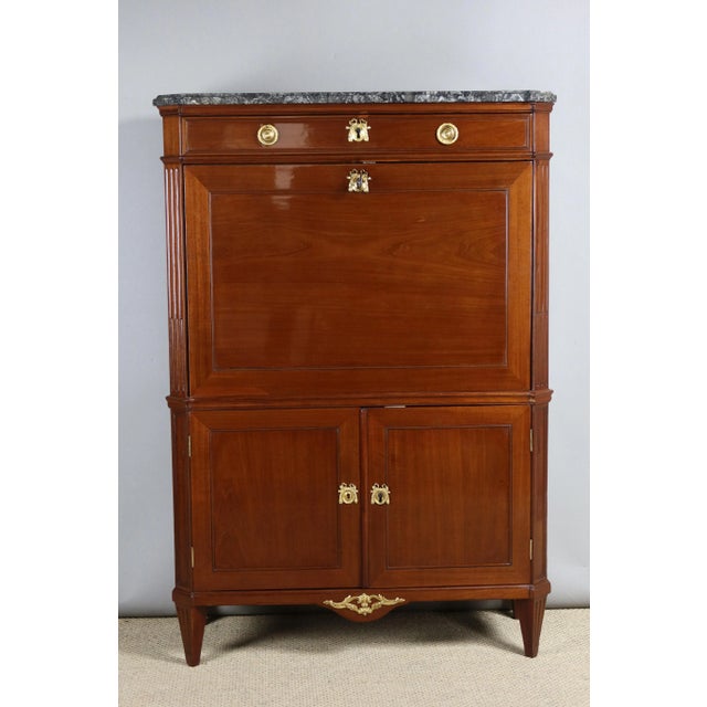 Louis xvi mahogany secretary stamped by the cabinetmaker nicolas petit with the jurande mark (jme). This secretary with...