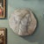 A beautifully executed hand-carved marble relief plaque depicting an idealized female profile, likely representing...