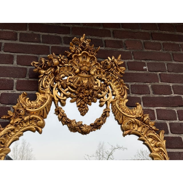 Add a refined and decorative touch to your interior with this elegant French Rococo style wall mirror, dating from around...