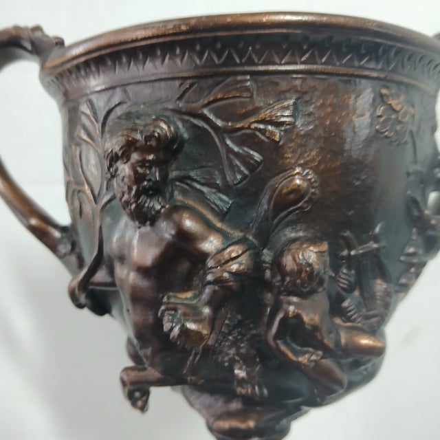 A wonderful bronze replica of this iconic drinking cup of the Greeks and Etruscans, mounted on a marble and wood base. 10"...
