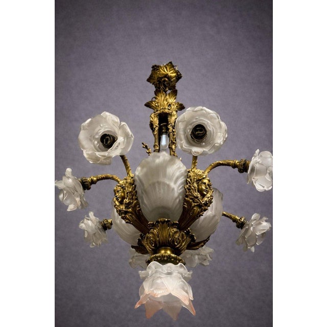 Important antique gilt bronze chandelier, adorned with opaline glass shells and flowers, Art Nouveau period The body is...