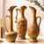 Set of three vintage Royal Haeger ewer vases in warm antique gold — collectible mid-century American art pottery, tall and...