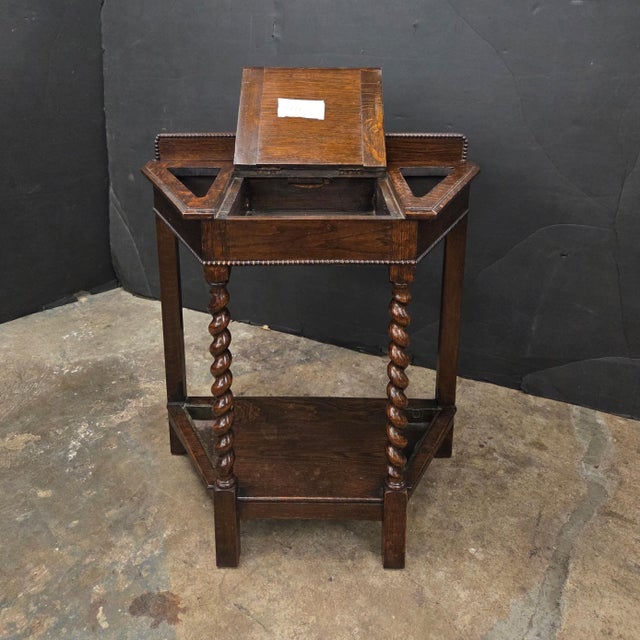 This English Oak Angled Front Barley Twist Front Leg Umbrella Stand has a lift up center for storage. It is a nice size...