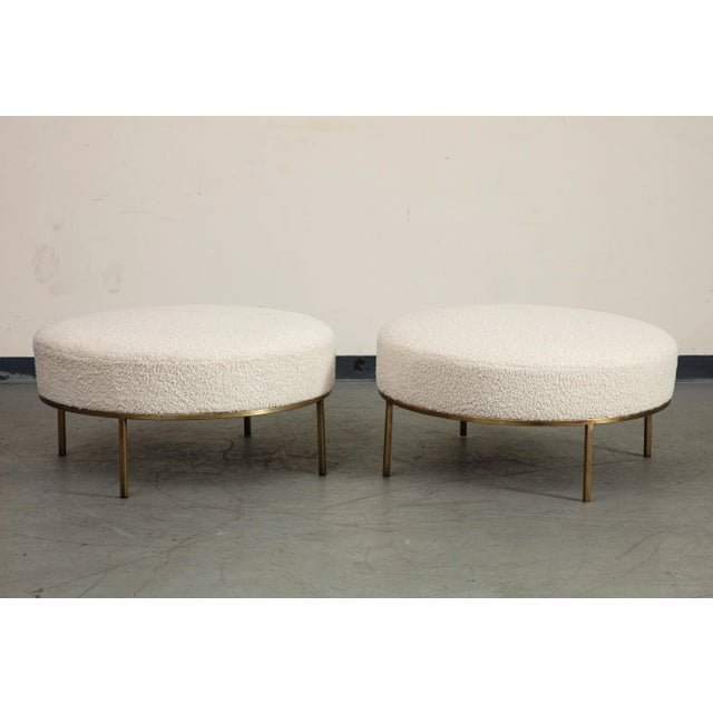 Pair of contemporary Chautauqua Round Ottomans by Amber Lewis, handmade in Los Angeles. Featuring bone bouclé upholstery...