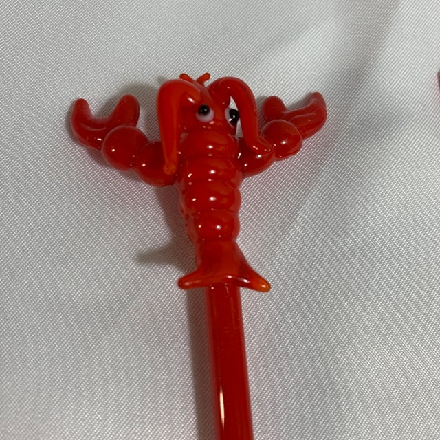 These items are red lobster swizzle sticks used for stirring drinks. Vintage C. 1990s Crate and Barrel, comes with...