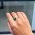 This Modern Toi-et-Moi ring showcases a 1.88 carat natural emerald and yellow diamond, set in 18k white gold. creating a...