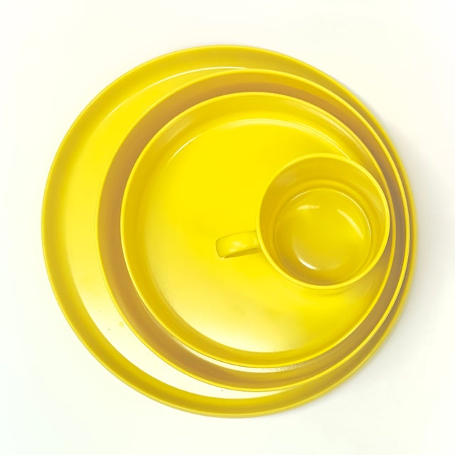 Yellow dinner set, group of 16. This eccentric 1970's yellow melamine dinner set is from the Oblique by PMC line. It...