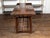 An American rustic pine log table from the early 20th century, with straight legs and side stretchers. Made in the USA...