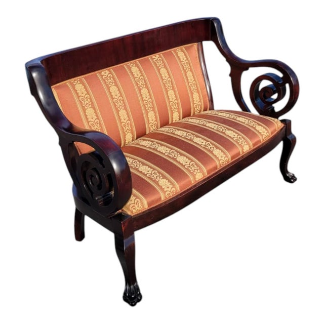 This 1920 American made loveseat is crafted from heavy solid mahogany with elegant twisted arms and classic carved...