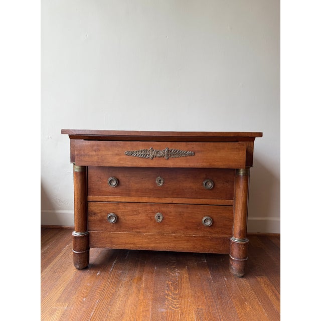 This 19th Century French Empire Buffet showcases refined craftsmanship with its elegant lines and rich walnut wood finish....