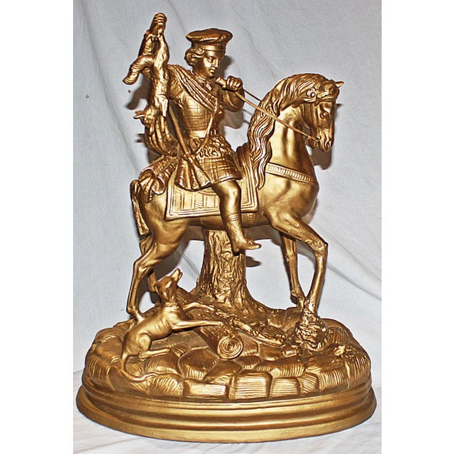 Right from a Hollywood Regency mansion, an antique gilded terracotta figurine, the rabbit hunter. Fresh French gilding wax...