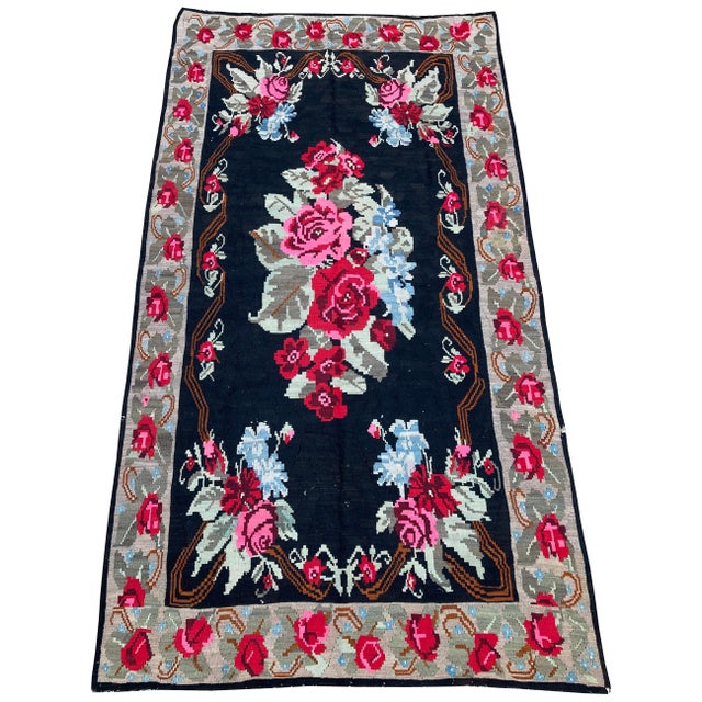 A beautiful Karabagh kilim, handwoven in the south Caucasus circa 1930’s with an extravagantly floral design on an ink...