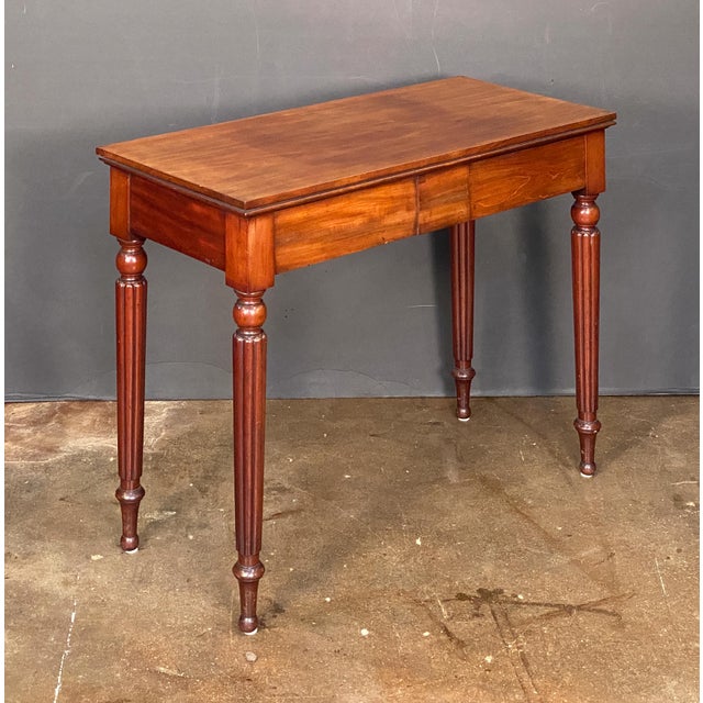 A fine English console serving or hall table of mahogany from the William IV era, featuring a rectangular top over a...