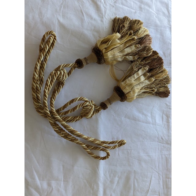Two gorgeous corded gold and beige organza ribbon tiebacks on wood like balls. An elegant touch to draperies. Making any...