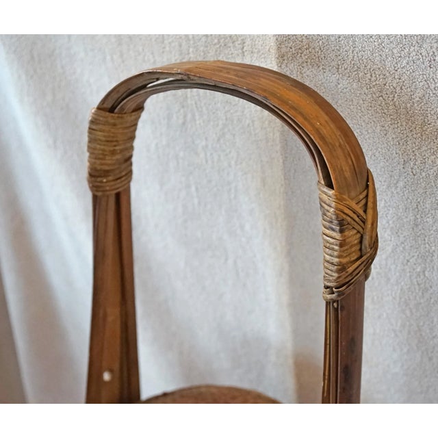 This long handled basket is out of Shanxi Province. There are the remnants of the original woven rattan floating "ring" on...