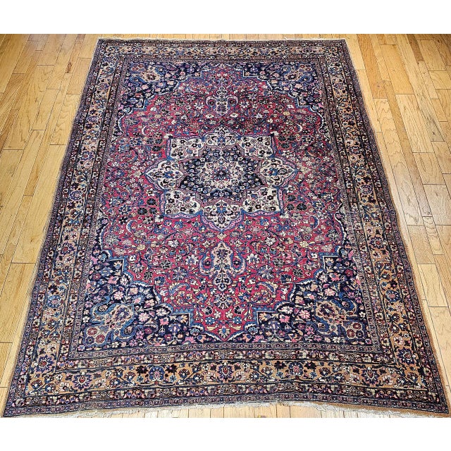 "This exquisite vintage Persian Khorassan rug, woven in the early 20th century. Set in a richly saturated crimson red...