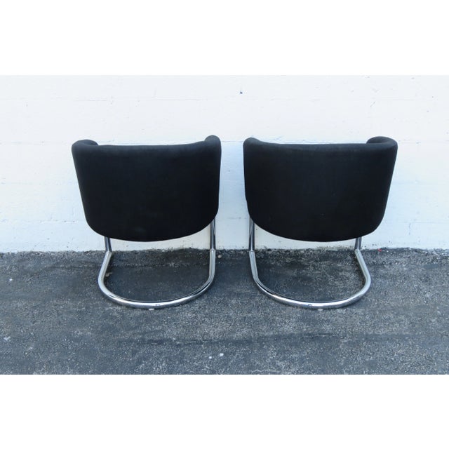 This Pair of Chairs are made of metal, Fabric, and they are in good condition. These two chairs have Mid Century Modern...