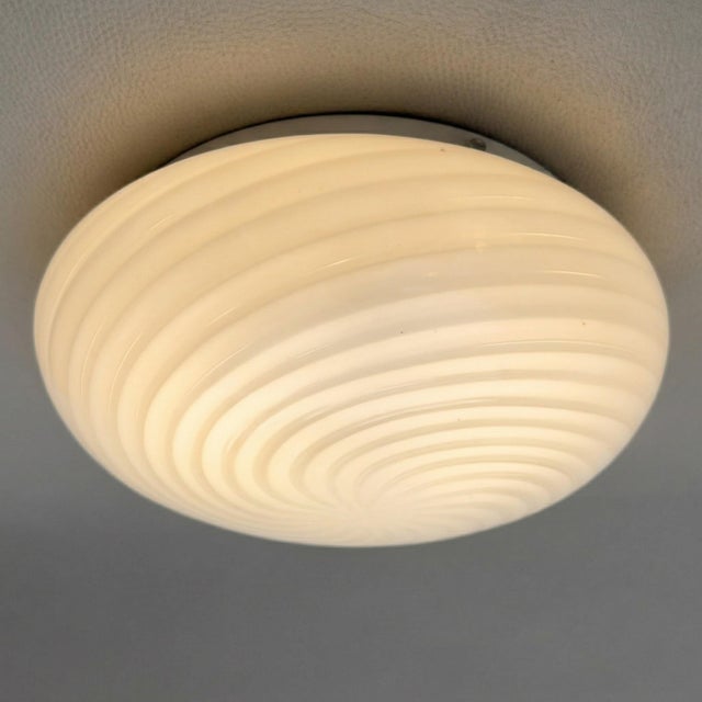 A refined lighting fixture with an enveloping and hypnotic allure, perfect for adding light, elegance, and character to...