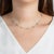 A chic way to add a pop of white and "heart" to your neck stack. Nine Mother of Pearl hearts with gold chain in between...