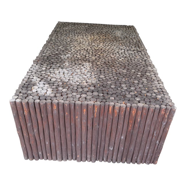 A showstopping coffee table built entirely from solid peeled logs in a Kahlua finish, topped with a dense end-grain “log...