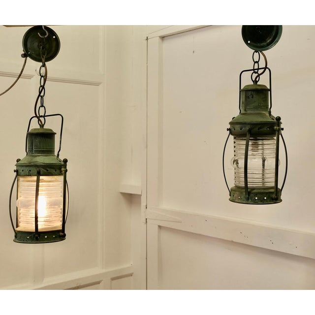 A Pair of Copper Ships Style Hanging Lights The lamps are round with thick bowed and ridged glass, they are in the style...