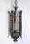 A tall, wrought iron lantern, late 19th century, French. Lantern is five-sided with open, quatrefoil-motif ironwork and...