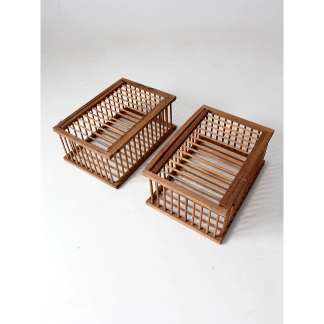 Pair of vintage wooden farm crates, circa mid-20th century. Constructed with hinged lids and bar-and-clip closures, the...