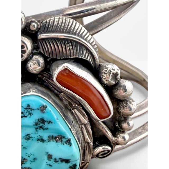 Bold 1970s Navajo sterling silver cuff featuring Sleeping Beauty turquoise, coral, and mother of pearl in a sculptural...