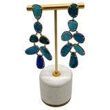These contemporary earrings showcase vibrant blue black opal stones, each set in a delicate gold frame. The design...
