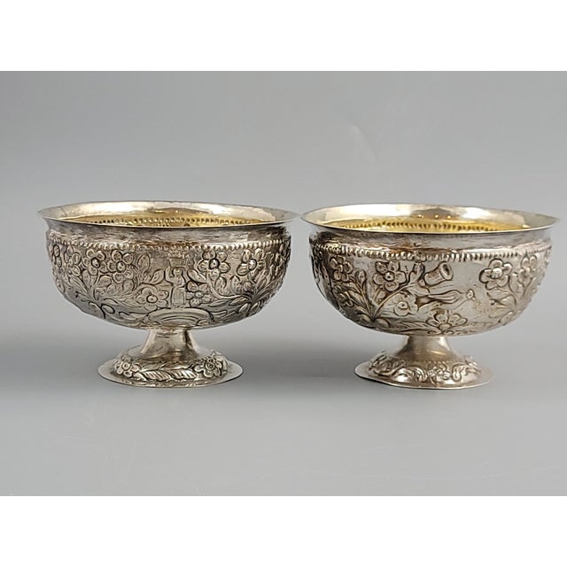 A substantial and decorative pair of Burmese silver bowls, made in Mandalay around 1900 and richly worked in hand-chased...