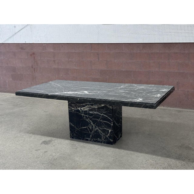 Postmodern Italian dining table in verde marble, late 20th century. Rectangular slab top in richly veined marble, showing...