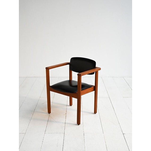 Teak chair with seat and backrest upholstered in black leather. Clean lines and exposed joints. Danish production, 1960s....