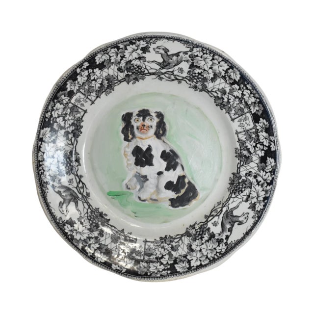 An portrait of an antique, c. 1850 Victorian English Staffordshire spaniel dog, black and white, in oils with a pale green...