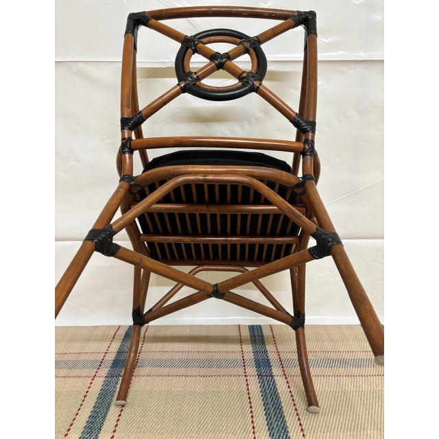 This is alleged iconic vintage McGuire Rattan 'Target Back' armchair, originally designed by Elinor McGuire. It features a...