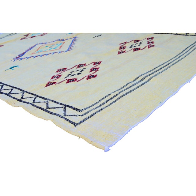 Handwoven Moroccan flat-weave wool and silk rug, featuring an elegant rhythmic pattern of colorful birds, intricate Berber...