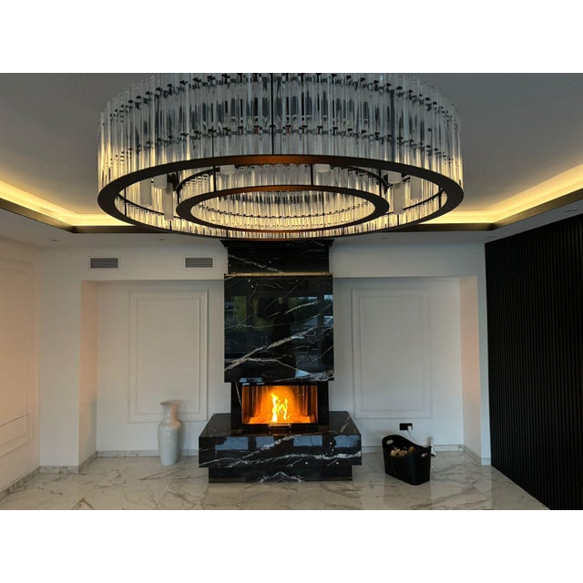 This impressive round chandelier from our own in house production combines modern design with an elegant lighting effect....
