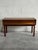 This exceptional accent piece features a minimalist rectangular tabletop sitting over a wide single storage drawer. The...