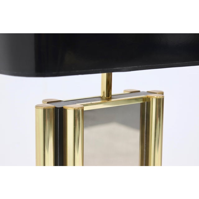 Beautiful large Belgian table lamp from the 1970s. The lamp base is made of mirrored glass with brass corner accents....