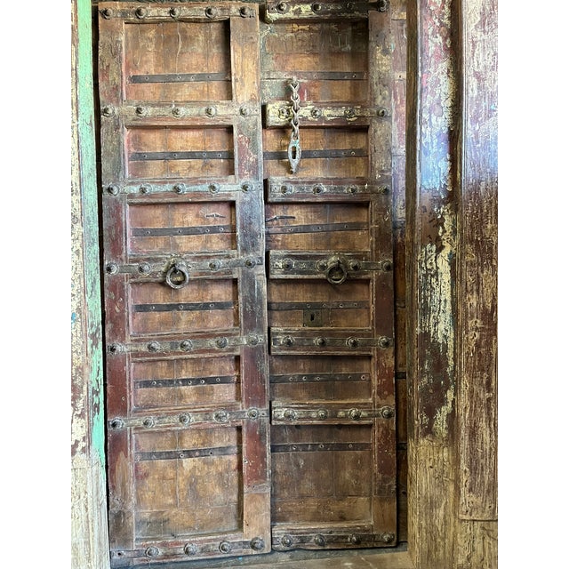 An extraordinary antique Indian door with original frame, handcrafted from reclaimed solid wood and rich with rustic...